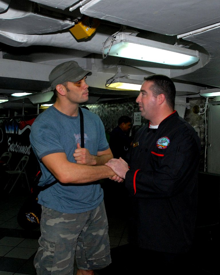 US Navy 080911-N-4995K-001 Ultimate Fighting Championship fighter Rich Franklin shakes hands with Culinary Specialist 2nd Class Jimmy McMaster after eating dinner with the crew aboard USS Ronald Reagan (CVN 76)