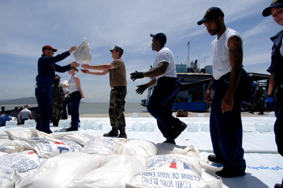 US Navy 080909-N-9620B-278 Sailors embarked aboard the amphibious assault ship USS Kearsarge (LHD 3) deliver more than 100,000 pounds of food and water for the victims of recent hurricanes that have struck Haiti