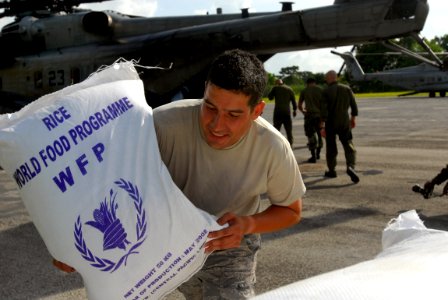 US Navy 080910-N-3595W-448 Military personnel embarked aboard the amphibious assault ship USS Kearsarge (LHD 3) prepare food and water supplies to be distributed to Haitian communities affected by recent hurricanes photo