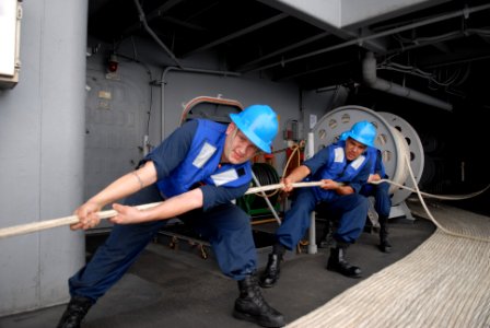 US Navy 080910-N-4005H-048 Boatswain's Mate 3rd Class Andrew Horner and Boatswain's Mate Seaman Willie Perry lean against the pull of a Larne Target Spar on the Fantail of the Nimitz-class aircraft carrier USS Ronald Reagan (CV