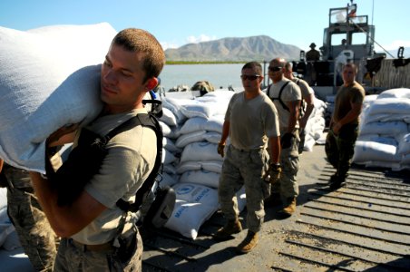 US Navy 080912-N-4515N-300 Service members embarked aboard the amphibious assault ship USS Kearsarge (LHD 3) unload food and supplies for delivery to areas affected by recent hurricanes photo