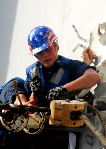 US Navy 080910-N-5148B-052 Boatswain's Mate 3rd Class Dustin Bailey prepares rigging aboard the amphibious dock landing ship USS Pearl Harbor (LSD 52) to receive supplies from USNS San Jose (T-AFS 7) during a connected replenis
