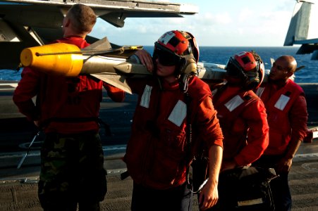 US Navy 110807-N-BT887-226 Sailors carry ordnance aboard USS John C. Stennis (CVN 74)