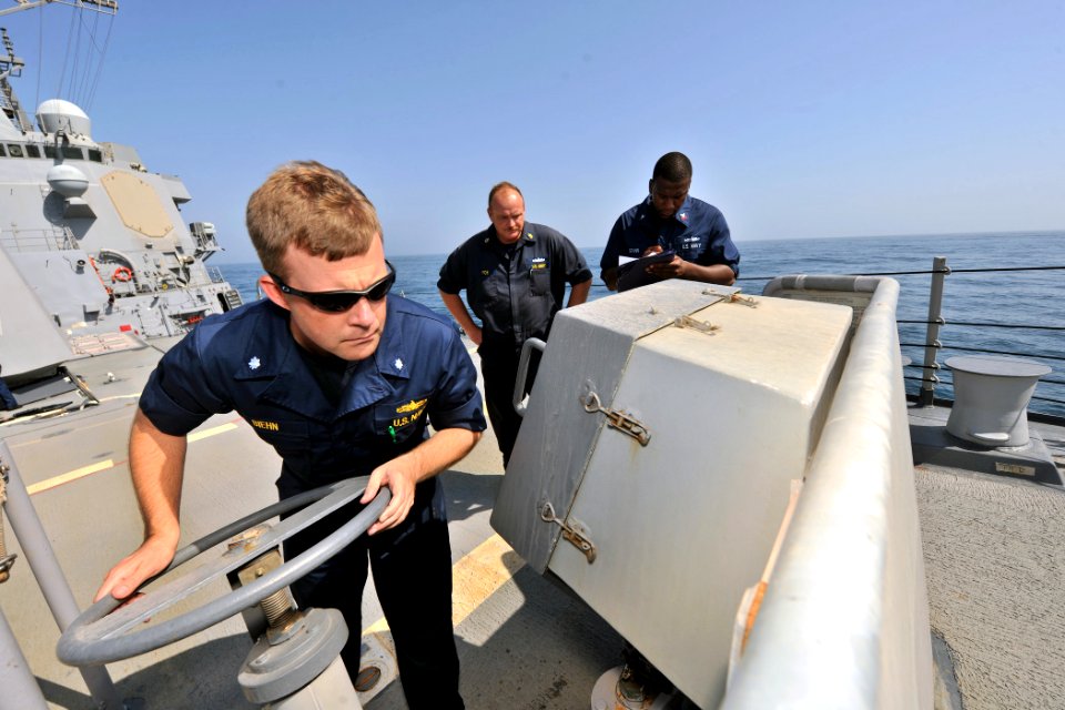 US Navy 110907-N-YZ751-051 Cmdr. Andrew M. Biehn inspects an anchor control station on the foc'sle aboard USS Truxtun (DDG 103)