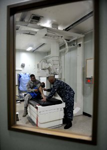 US Navy 110822-F-ET173-086 A Hospital Corpsman X-rays a patients foot aboard the USNS Comfort