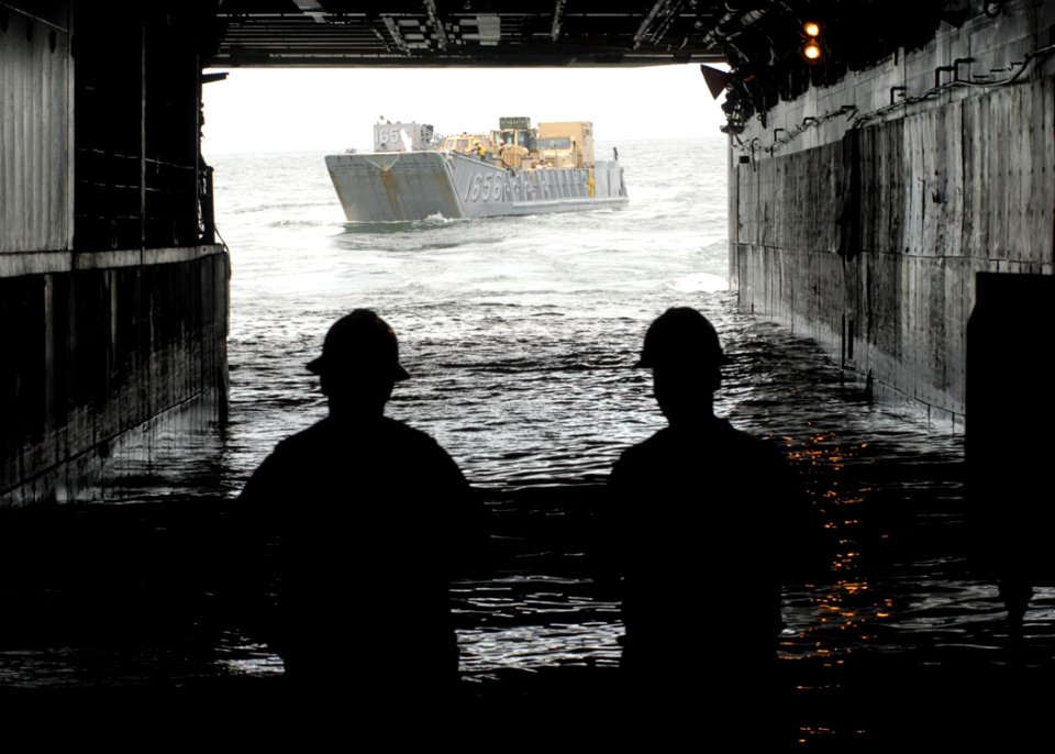 US Navy 080912-N-6439C-050 ailors aboard the amphibious assault ship USS Nassau (LHA 4) watch as a landing craft from Assault Craft Unit (ACU) 2, based at Naval Amphibious Base Little Creek, Va., prepares to embark aboard the s