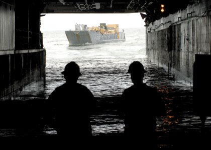 US Navy 080912-N-6439C-050 ailors aboard the amphibious assault ship USS Nassau (LHA 4) watch as a landing craft from Assault Craft Unit (ACU) 2, based at Naval Amphibious Base Little Creek, Va., prepares to embark aboard the s