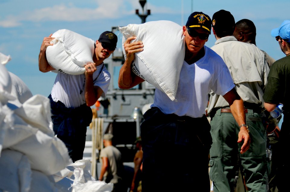 US Navy 080912-N-4515N-976 Service members embarked aboard the amphibious assault ship USS Kearsarge (LHD 3) unload food and supplies for delivery to areas affected by recent hurricanes