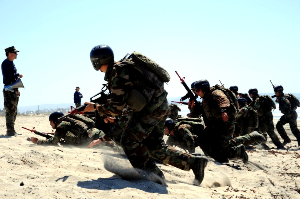 US Navy 080910-N-6552M-248 Crewman Qualification Training (CQT) students charge the beach during a medical evacuation drill at the Naval Special Warfare Center in Coronado