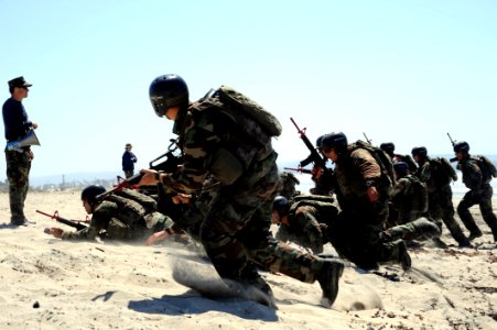 US Navy 080910-N-6552M-248 Crewman Qualification Training (CQT) students charge the beach during a medical evacuation drill at the Naval Special Warfare Center in Coronado photo