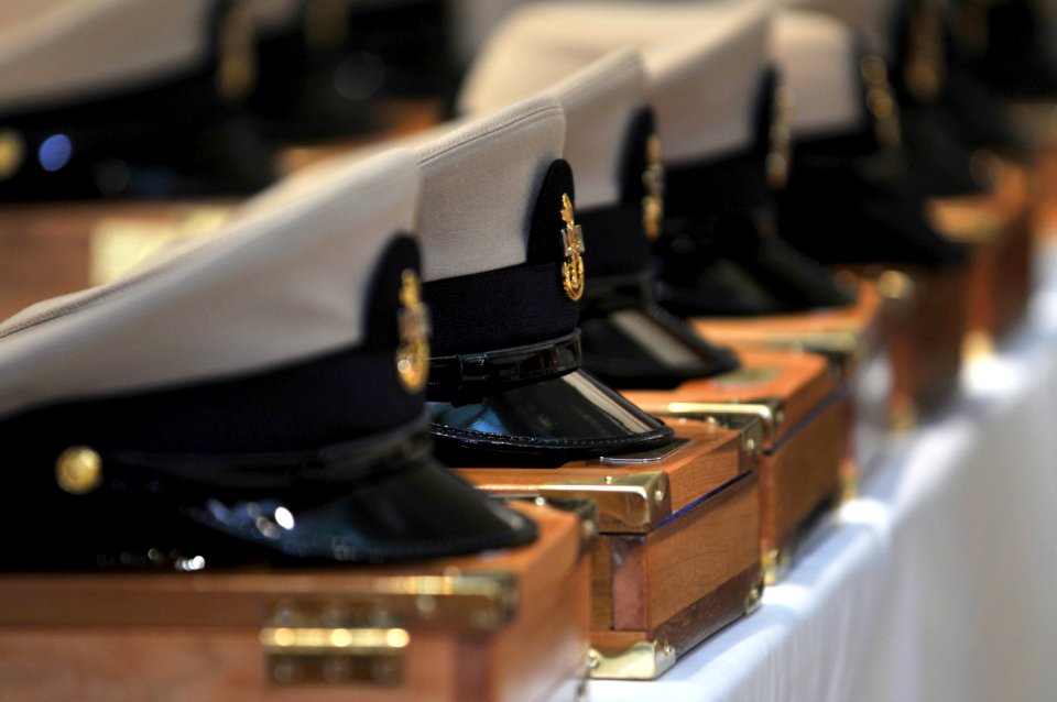 US Navy 080916-N-5328N-174 Chief petty officer combination covers rest on the charge books of the Navy's newest chief petty officers