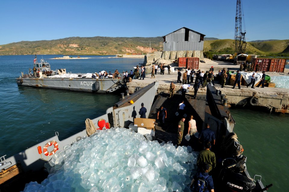 US Navy 080915-N-8907D-039 Service members embarked aboard the amphibious assault ship USS Kearsarge (LHD 3) unload food and water during disaster relief support to areas affected by recent hurricanes in Haiti