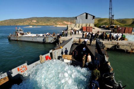 US Navy 080915-N-8907D-039 Service members embarked aboard the amphibious assault ship USS Kearsarge (LHD 3) unload food and water during disaster relief support to areas affected by recent hurricanes in Haiti photo