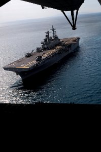 US Navy 080913-N-5642P-239 The amphibious assault ship USS Kearsarge (LHD 3) is seen from the ramp of a CH-53 Super Stallion helicopter departing for Port-au-Prince, Haiti, for disaster relief supplies photo