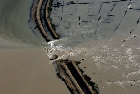 US Navy 080914-N-3595W-024 A levy that separates Port-au-Prince and Les Cais is broken due to Hurricane Ike