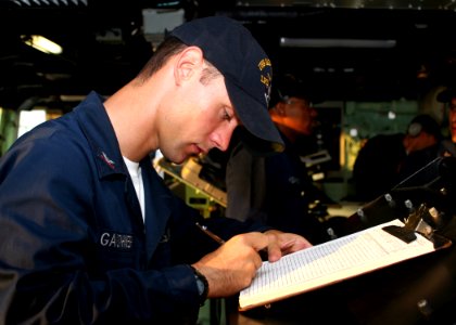 US Navy 080916-N-6764G-050 eoman 2nd Class Lucien Gauthier logs commands and actions on the bridge of the amphibious transport dock ship USS San Antonio (LPD 17)