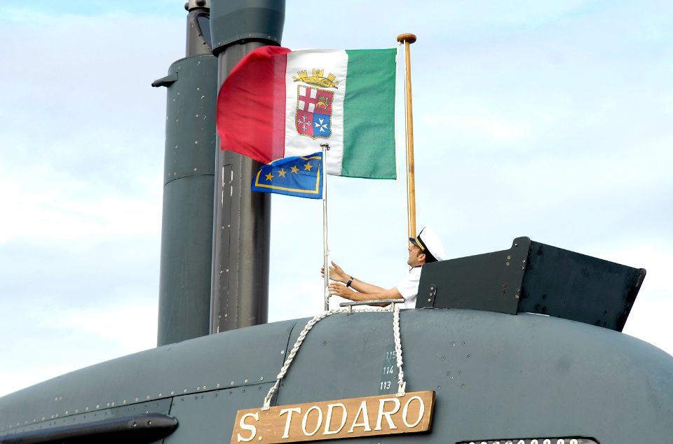 US Navy 080916-N-8467N-003 Adm. Paolo La Rosa adjusts the Italian flag while taking a tour of Italian submarine ITS Salvatore Todaro (S 526)