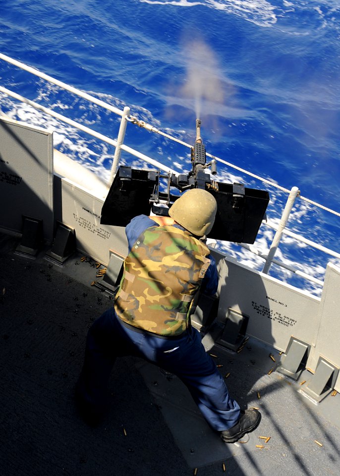 US Navy 080915-N-1082Z-013 Gunners Mate 1st Class Robert E. Lambert fires a .50 caliber machine gun during a live fire exercise aboard the guided-missile cruiser USS Vella Gulf (CG 72)