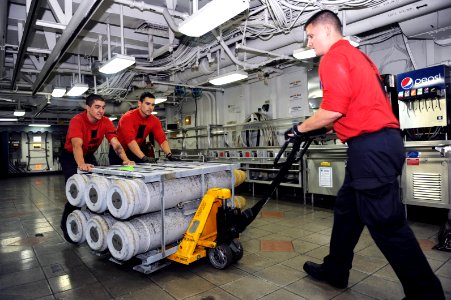 US Navy 110721-N-AU622-176 Sailors move ordnance on the mess decks of USS Dwight D. Eisenhower (CVN 69) during an ammunition onload
