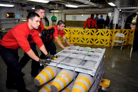 US Navy 110721-N-AU622-179 Sailors move ordnance on the mess decks of USS Dwight D. Eisenhower (CVN 69) during an ammunition onload