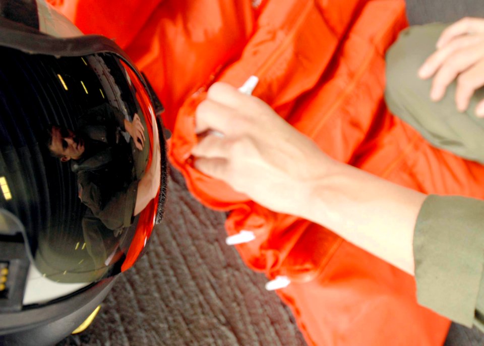 US Navy 080915-N-6439C-020 Aviation Warfare Systems Operator Airman Chris Carpenter performs operational checks on search and rescue gear