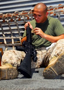 US Navy 080912-N-5148B-050 Hospital Corpsman 3rd Class Steven Lane cleans his M-16 rifle