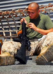 US Navy 080912-N-5148B-050 Hospital Corpsman 3rd Class Steven Lane cleans his M-16 rifle photo