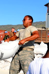 US Navy 080915-N-7955L-032 Staff Sgt. Julio Arriola, embarked aboard the amphibious assault ship USS Kearsarge (LHD 3), helps move supplies during a humanitarian assistance mission in Haiti photo