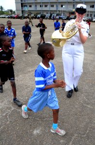 US Navy 080915-N-7526R-186 Musician 2nd Class Allison Baine plays as students at the Prytanee military school in Libreville march around her