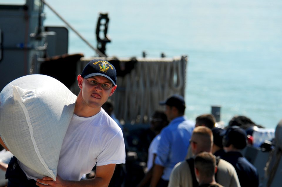 US Navy 080912-N-4515N-702 ervice members embarked aboard the amphibious assault ship USS Kearsarge (LHD 3) unload food and supplies for delivery to areas affected by recent hurricanes