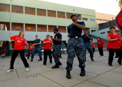 US Navy 110625-N-ZI300-152 Sailors a take part in latin-style dancing with a women's dance group during a community service event
