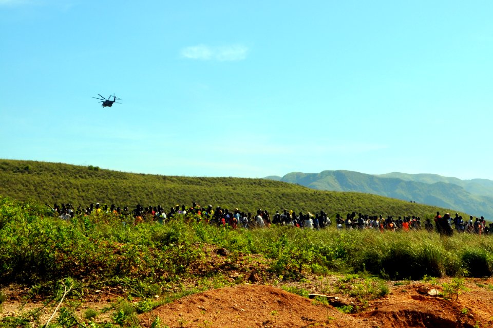 US Navy 080917-N-4515N-013 Haitians gather at a landing zone as medical personnel from the amphibious assault ship USS Kearsarge (LHD 3) arrive