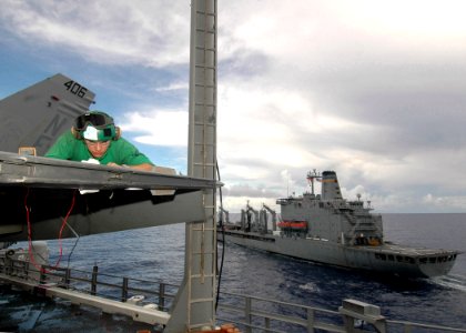 US Navy 080917-N-7282P-033 Aviation Electrician's Mate 3rd Class Dustin Brossard trouble shoots an AIM 9X Sidewinder missile grip