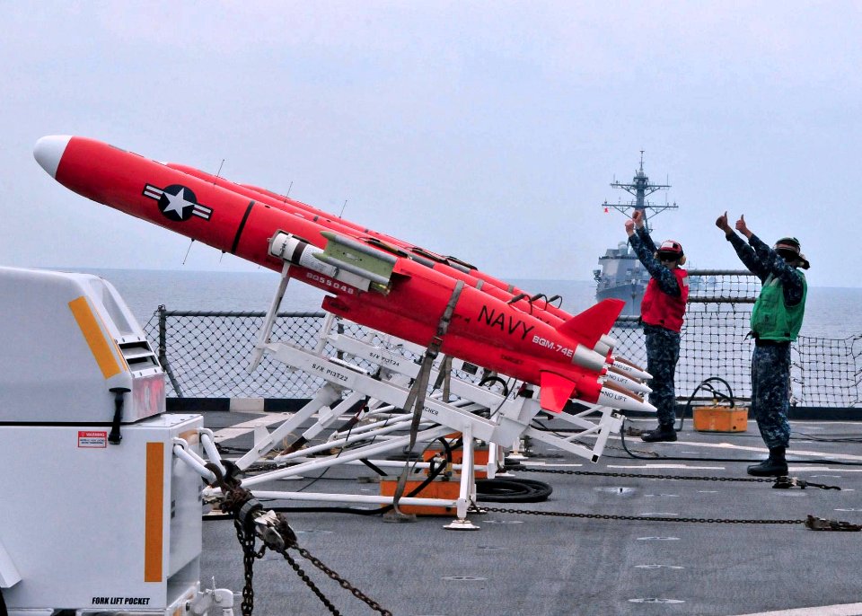 US Navy 110611-N-XR557-160 Sailors signal that a BQM-74 target drone is prepared for launch from the amphibious dock landing ship USS Tortuga (LSD