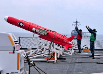 US Navy 110611-N-XR557-160 Sailors signal that a BQM-74 target drone is prepared for launch from the amphibious dock landing ship USS Tortuga (LSD
