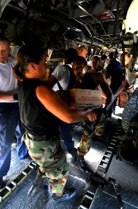 US Navy 080913-N-7955L-037 Service members embarked aboard the amphibious assault ship USS Kearsarge (LHD 3) load supplies onto helicopters for delivery to areas affected by recent hurricanes in Haiti