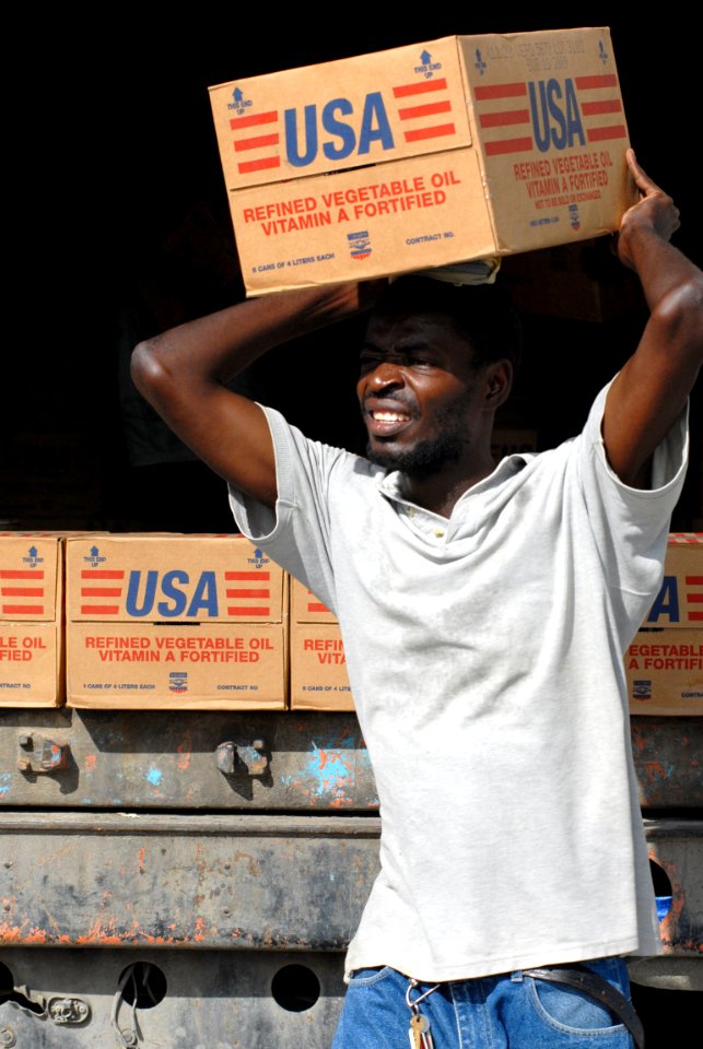 US Navy 080916-N-3595W-055 A Port-au-Prince citizen carries supplies to be delivered to communities affected by Hurricane Ike