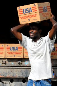 US Navy 080916-N-3595W-055 A Port-au-Prince citizen carries supplies to be delivered to communities affected by Hurricane Ike
