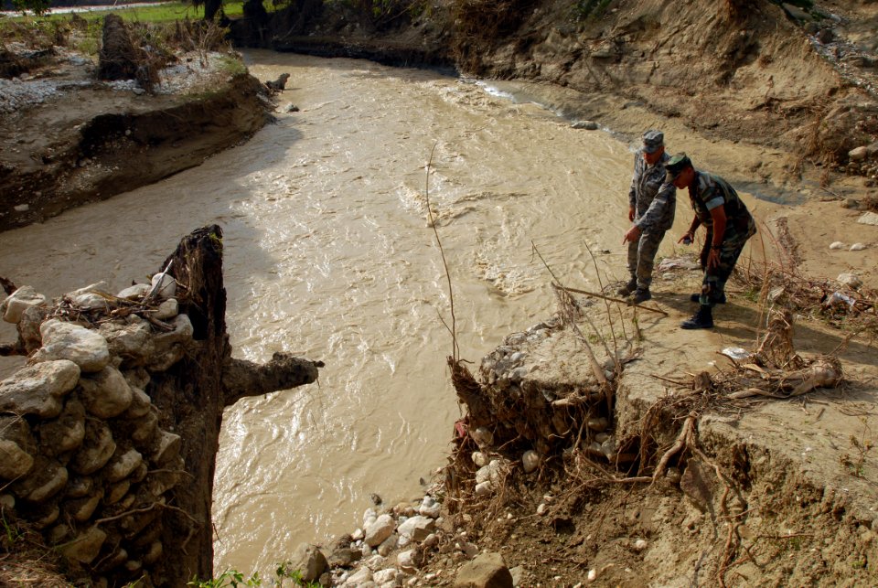 US Navy 080918-N-3595W-312 Air Force engineers and Navy Seabees embarked aboard the amphibious assault ship USS Kearsarge (LHD 3) inspect a bridge in a small community between Cabaret and Cazales that was damaged by Hurricane I