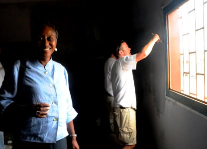 US Navy 080916-N-7526R-437 U.S. Ambassador to Gabon Eunice Reddick observes the progress members of the European region U.S. Navy soccer team have made painting a classroom during a community relations project