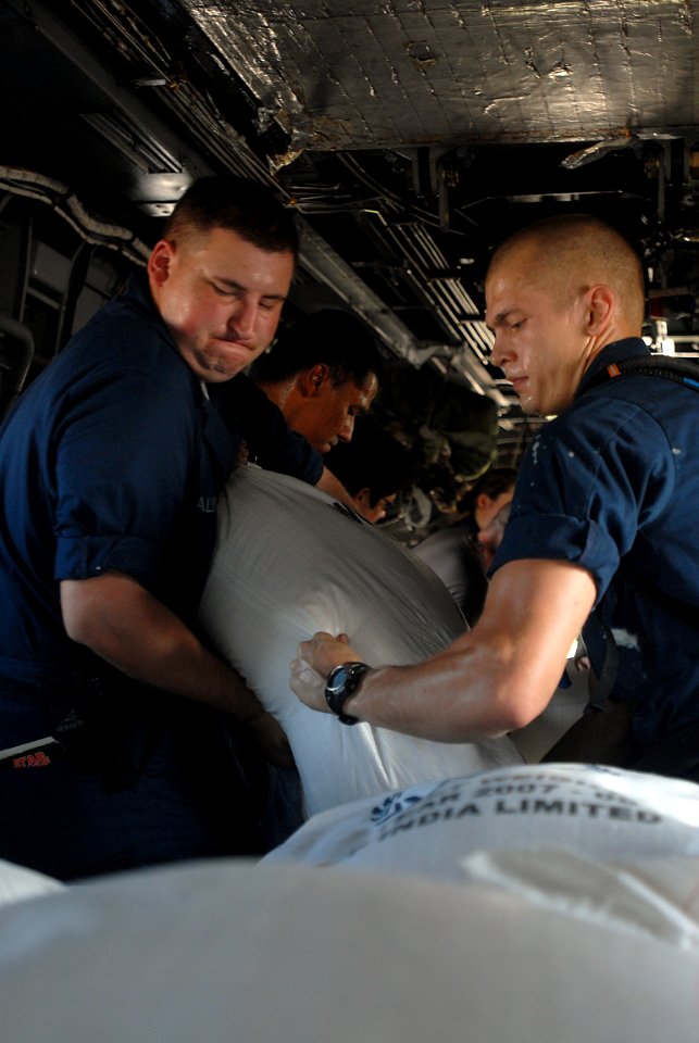 US Navy 080914-N-3595W-145 Service members embarked aboard the amphibious assault ship USS Kearsarge (LHD 3) load supplies onto a CH-53E Super Stallion helicopter for delivery to areas affected by recent hurricanes in Haiti