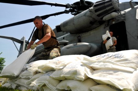 US Navy 080914-N-7544A-227 Sailors and Airmen embarked aboard the amphibious assault ship USS Kearsarge (LHD 3) unload food and supplies for delivery to areas affected by recent hurricanes photo