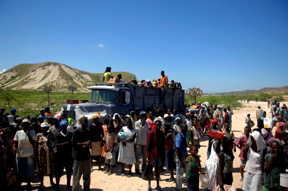 US Navy 080915-N-1508S-021 Haitian families wait in line to receive food and fresh water from U.N. officials during relief efforts in areas of Haiti devastated by recent hurricanes