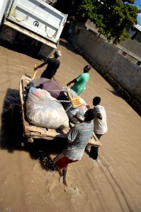 US Navy 080915-N-1508S-199 A group of Haitian men salvage personal belongings from their flooded homes in Gonaives, an area of Haiti devastated by recent hurricanes