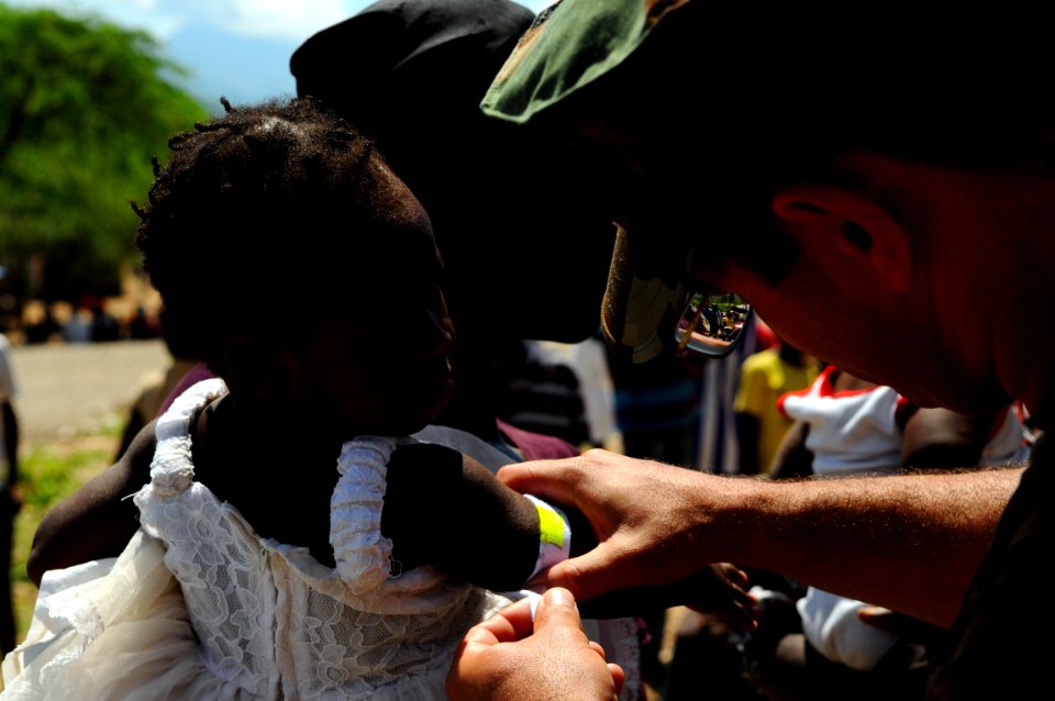 US Navy 080917-N-4515N-223 Lt. Hector Acevedo measures a child's arm circumference and height