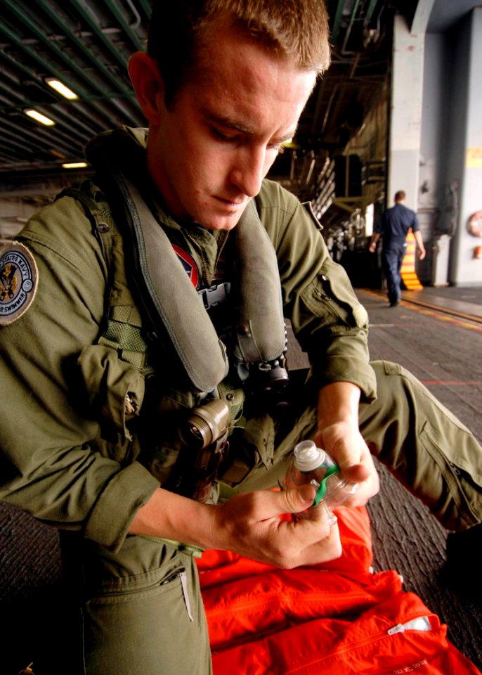 US Navy 080915-N-6439C-022 Aviation Warfare Systems Operator Airman Chris Carpenter performs operational checks on search and rescue gear