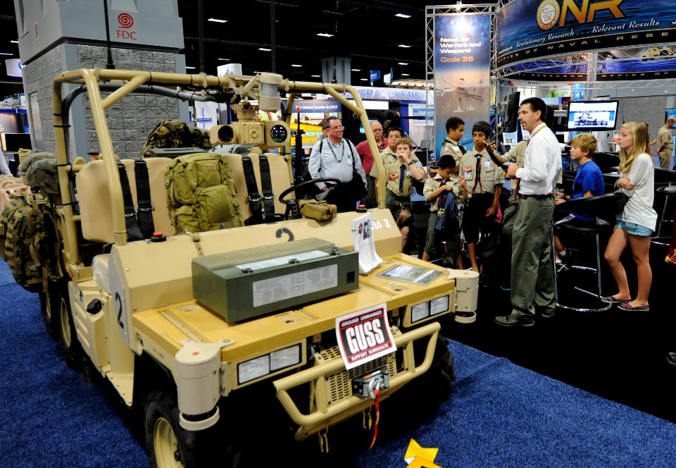 US Navy 110818-N-PO203-071 Brent Azzarelli, assigned to the Marine Corps Warfighting Laboratory, explains the Ground UnManned Support Surrogate