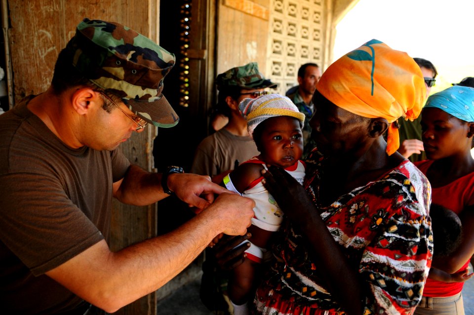 US Navy 080917-N-4515N-225 Lt. Hector Acevedo measures a child's arm circumference and height photo