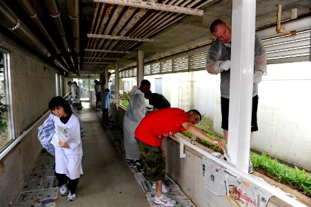 US Navy 110630-N-OX597-008 Sailors paint during a community service project at the Tsukumo En Challenged Home in Sasebo, Japan