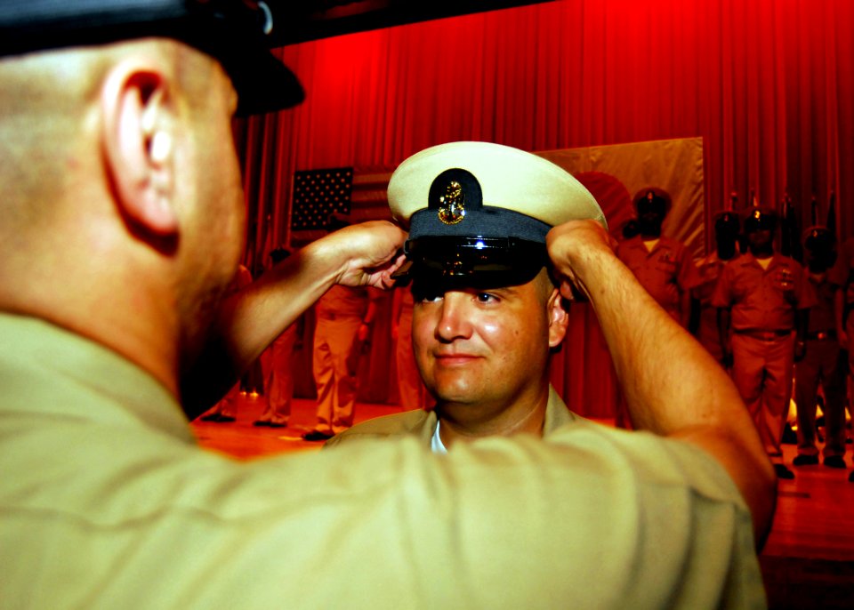 US Navy 080916-N-2013O-003 Chief Aviation Boatswain's Mate (Handling) Edward Rodrigues is presented his chief petty officer (CPO) combination cover